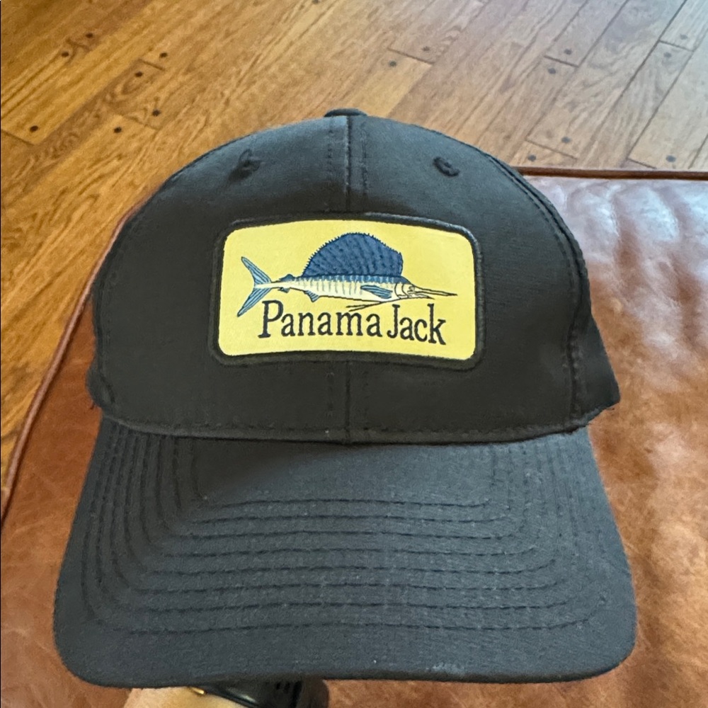 New Without Tags, Panama Jack Black Cap with Blue Fish Logo. Velcro strap